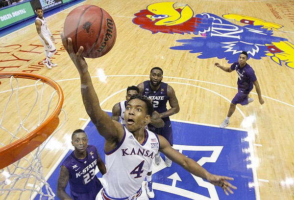 Kansas guard Devonte Graham (4) gets in for a bucket against Kansas State during the second half on Saturday, Jan. 31, 2015 at Allen Fieldhouse.
