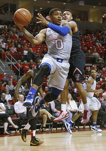Kansas guard Frank Mason III, (0) passes from beneath the basket during the Jayhawks 73-51 win against Texas Tech Tuesday, Feb. 10, 2015 at United Supermarkets Arena.