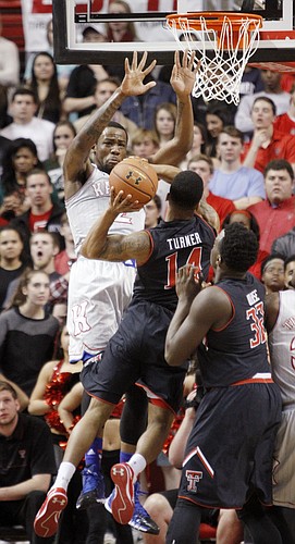 Kansas forward Cliff Alexander (2) left attempts a block on  Texas Tech guard Robert Turner (14) during the first half on Tuesday, Feb. 10, 2015 at United Supermarkets Arena.