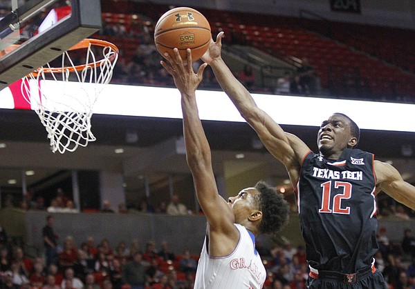 Kansas guard Devonte Graham, left, gets a shot blocked by Texas Tech guard Keenan Evans (12) during the Jayhawks 73-51 win Tuesday, Feb. 10, 2015 at United Supermarkets Arena.