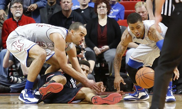 Kansas forward Perry Ellis, left, and guard Frank Mason III, go for a loose ball during the Jayhawks 73-51 win over Texas Tech Tuesday, Feb. 10, 2015 at United Supermarkets Arena.