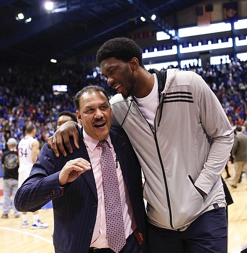 Philadelphia 76ers center Joel Embiid chats up Kansas assistant coach Kurtis Townsend on the way to the locker room following the Jayhawks' 74-64 win over Baylor on Saturday, Feb. 14, 2015 at Allen Fieldhouse.