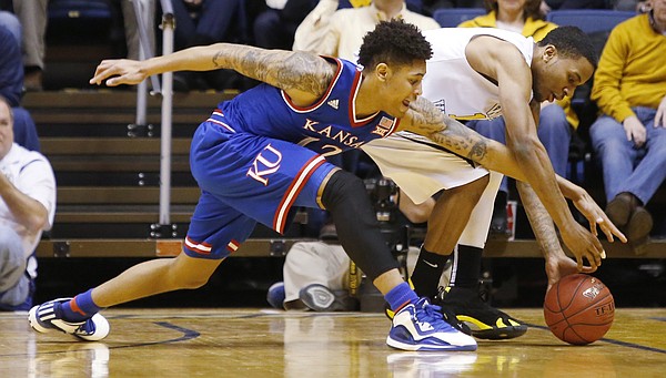 Kansas guard Kelly Oubre, Jr. (12) attempts a steal from West Virginia guard Tarik Phillip (12) during the Jayhawks 62-61 loss to the Mountaineers Monday, February 16, 2105  in Morgantown, W.V.
