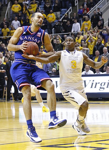 Kansas forward Perry Ellis (34) is defended by West Virginia guard Juwan Staten (3) after Ellis caught a long pass from Jamari Traylor in an attempt for a last-second shot at the end of the Jayhawks 62-61 loss game against the West Virginia Mountaineers Monday, February 16, 2105  in Morgantown, W.V.