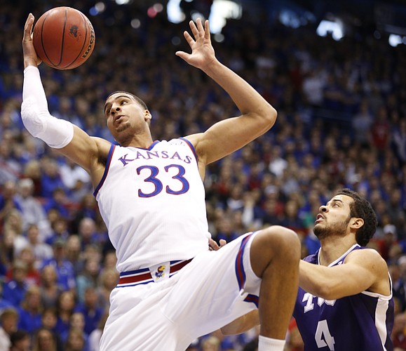 Kansas forward Landen Lucas (33) catches a pass in the paint before TCU forward Amric Fields (4) during the first half, Saturday, Feb. 21, 2015 at Allen Fieldhouse.