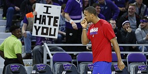 Kansas guard Wayne Selden Jr. hides a smile as he and the Jayhawks receive a less than warm welcome as they take the court for warmups prior to tipoff against Kansas State, Monday, Feb. 23, 2015 at Bramlage Coliseum.