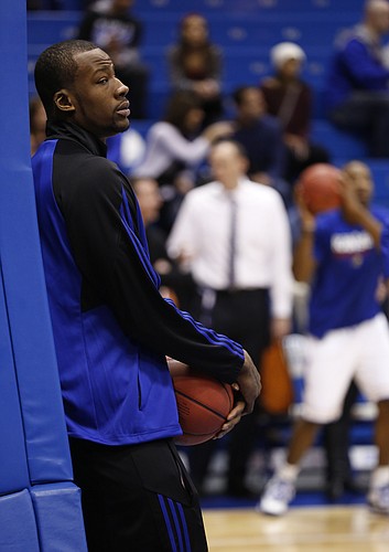 Kansas forward Cliff Alexander watches warmups on Saturday, Feb. 28, 2015 at Allen Fieldhouse. Kansas University officials announced that Alexander will not play against Texas after they were alerted to a potential eligibility issue involving Alexander by the NCAA.