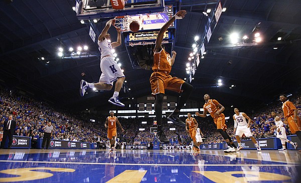 Kansas forward Perry Ellis (34) delivers a dunk against Texas center Prince Ibeh during the first half on Saturday, Feb. 28, 2015 at Allen Fieldhouse.