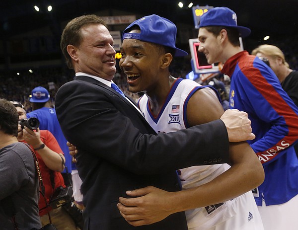 Kansas coach Bill Self hugs Devonte Graham (4) after a 76-69 win over the West Virginia Mountaineers Tuesday, March 4, 2015 at Allen Fieldhouse..