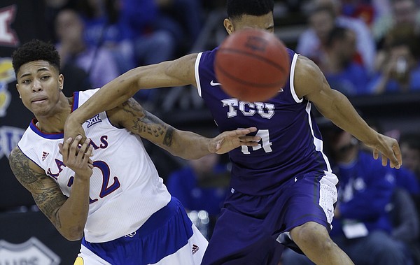 Kansas guard Kelly Oubre, Jr. (12) knocks the ball loose from TCU's Karviar Shepard (14) in the Jayhawk’s 64-59 win over TCU Thursday at the Sprint Center in Kansas City, MO.