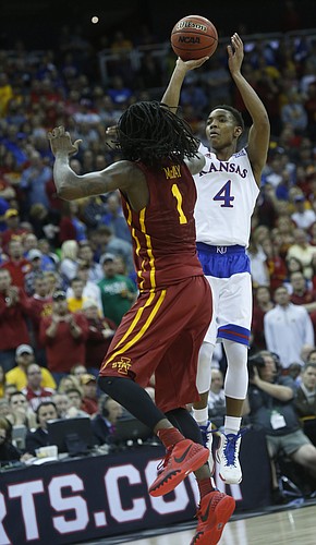 Kansas guard Devonte Graham (4) shoots for a three-point basket over Iowa State's Jameel McKay during the Jayhawk’s loss to Iowa State Saturday.
