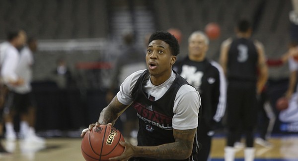 New Mexico State senior guard Daniel Mullings warms up with his team during a practice session at the CenturyLink Center in Omaha, NE., Thursday, March 19, 2015.
 