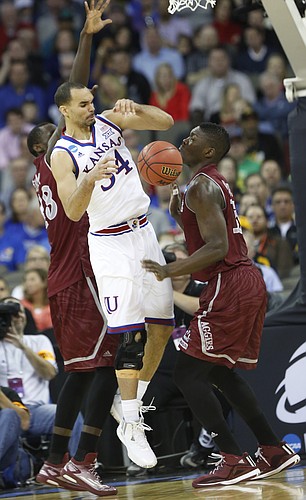 Kansas forward Perry Ellis (34) is stripped of the ball by New Mexico State guard Daniel Mullings (23) and center Tshilidzi Nephawe (15) in the Jayhawks second-round NCAA tournament game against New Mexico State Friday, March 20, 2015 at the CenturyLink Center, Omaha, Neb.