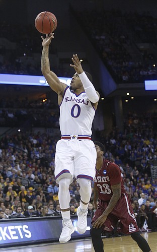 Kansas guard Frank Mason III (0) lays in two of his 17 points in the Jayhawks' 75-56 win against New Mexico State Friday, March 20, 2015 at the CenturyLink Center, Omaha, NE.