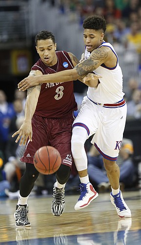 Kansas guard Kelly Oubre, Jr. (12) puts pressure on New Mexico State forward Remi Barry (3) in the Jayhawks win over New Mexico State Friday, March 20, 2015 at the CenturyLink Center, Omaha, NE.