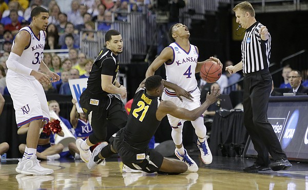 Kansas guard Devonté Graham (4) is fouled after getting a steal on Wichita State center Tom Wamukota (21) in the Jayhawks' third-round NCAA Tournament game against Wichita State Sunday, March 22, 2015 at the CenturyLink Center, Omaha, Neb.