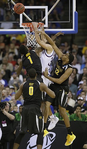 Kansas forward Perry Ellis is fouled on a dunk attempt  in the Jayhawks' 78-65 loss to Wichita State Sunday, March 22, 2015 at the CenturyLink Center, Omaha, Neb.