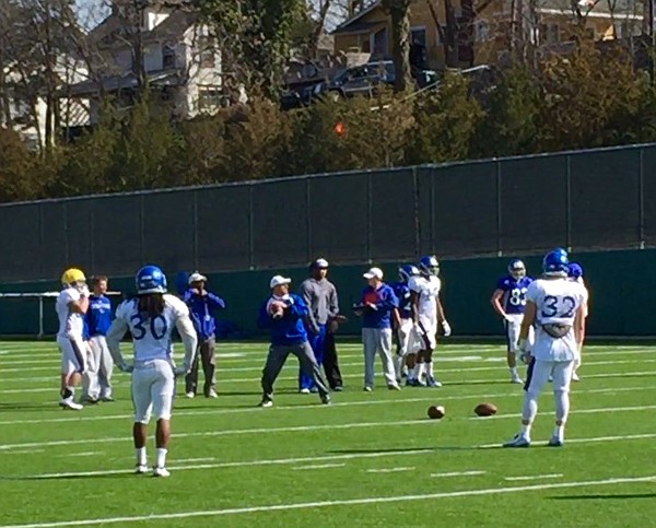 David Beaty, playing quarterback instead of head coach, looks to throw during a drill for KU's cornerbacks at Saturday's practice. 