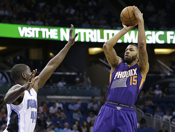 Phoenix Suns' Marcus Morris (15) makes a shot over Orlando Magic's Andrew Nicholson (44) during the first half of an NBA basketball game, Wednesday, March 4, 2015, in Orlando, Fla. (AP Photo/John Raoux)
