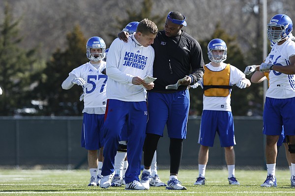 Special Teams coach Gary Hyman left, and Darius Willis right, talk about drills on Thursday March 26, 2015.