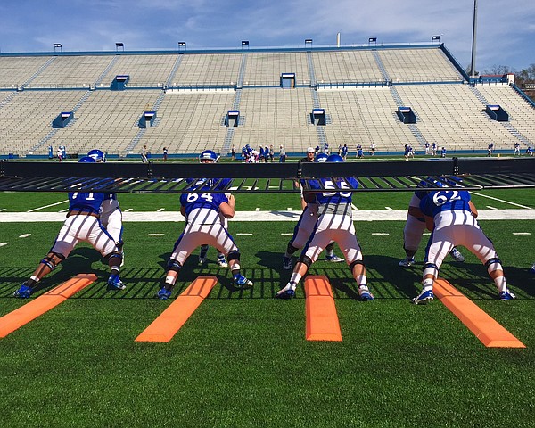 KU's offensive line runs through a drill at Friday's practice. 