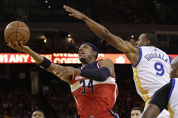 Washington Wizards forward Paul Pierce (34) shoots against Golden State Warriors forward Andre Iguodala (9) during the first half of an NBA basketball game in Oakland, Calif., Monday, March 23, 2015. (AP Photo/Jeff Chiu)
