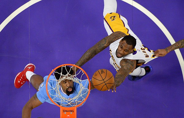 Los Angeles Clippers center DeAndre Jordan, left, and Los Angeles Lakers forward Tarik Black battle for a rebound as Clippers forward Matt Barnes grabs Blacks jersey during the first half of an NBA basketball game, Sunday, April 5, 2015, in Los Angeles. (AP Photo/Mark J. Terrill)
