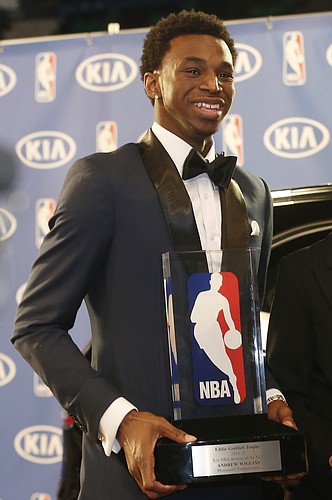 Minnesota Timberwolves' Andrew Wiggins holds his trophy at a news conference after he was named NBA basketball Rookie of the Year, Thursday, April 30, 2015, in Minneapolis. (AP Photo/Jim Mone)

