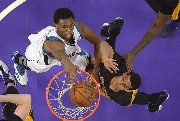 Minnesota Timberwolves forward Andrew Wiggins, left, dunks as Los Angeles Lakers guard Jordan Clarkson defends during the second half of an NBA basketball game, Friday, April 10, 2015, in Los Angeles. The Lakers won 106-98. (AP Photo/Mark J. Terrill)