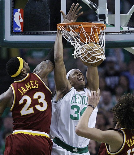 Boston Celtics forward Paul Pierce, center, dunks as Cleveland Cavaliers forward LeBron James, left, and center Anderson Varejao of Brazil, right, watch during the second half of Game 4 in a second-round NBA basketball playoff series, Sunday, May 9, 2010, in Boston. The Celtics won 97-87, tying the series at 2-2. (AP Photo/Charles Krupa)

