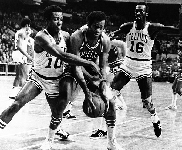 Chet Walker of the Chicago Bulls is guarded by Jo Jo White of the Boston Celtics (10), as he tried to lay up a shot in their game in Boston at night on Jan. 13, 1972. Tom Sanders of Celtics Comes in at right. Boston won the game 113-112. (AP Photo)
