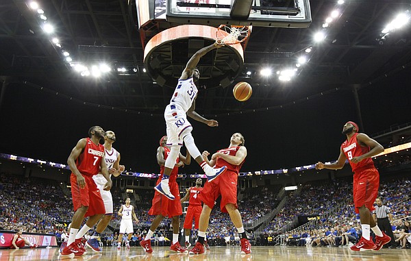 Kansas forward Jamari Traylor (31) delivers a tomahawk dunk over members of Team Canada during the third quarter of Friday's World University Games exhibition at Sprint Center.