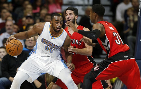 Denver Nuggets forward Darrell Arthur, left, is stopped as he tries to drive to the basket for a shot by Toronto Raptors guards Greivis Vasquez, center, of Venezuela, and Terrence Ross in the first quarter of an NBA basketball game Sunday, Dec. 28, 2014, in Denver. (AP Photo/David Zalubowski)
