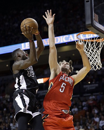 Miami Heat forward James Ennis (32) goes to the basket as New Orleans Pelicans center Jeff Withey (5) defends in the second half of an NBA basketball game in Miami, Saturday, Feb. 21, 2015. The Pelicans won 105-91. (AP Photo/Alan Diaz)
