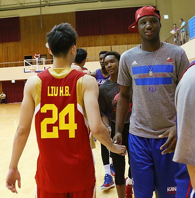 Kansas forward Carlton Bragg shakes hands with Team China players after a Team USA 93-56 win in a scrimmage game Thursday, July 2. Bragg who has a broken nose, sat out the scrimmage. 
