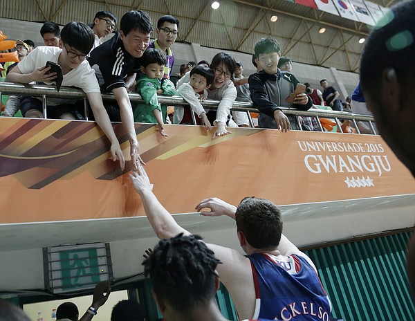 Kansas center Hunter Mickelson (42) reaches to touch fans while leaving the court after a Team USA 81-72 win over against Brazil Sunday, July 5, in Gwangju, South Korea.
