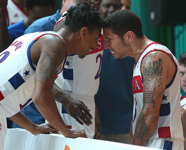 Team USA guard Julian DeBose (12) and Team USA guard Nic Moore (3) bump heads after Moore hit a three-point basket late in a Team USA 66-65 win against Serbia Wednesday, July 8, at the World University Games in South Korea.