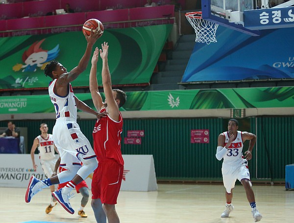 Team USA guard Julian DeBose (12) drives to the basket for two of his team-leading 18 in a Team USA game against Switzerland Thursday, July 9, at the World University Games in South Korea.
