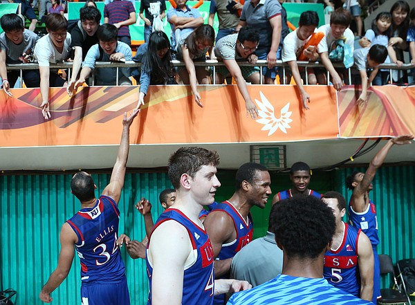 Fans reach to shake hands with Team USA players after the United States' 78-68 semifinal win over Russia on Sunday, July 12, 2015, at the World University Games in South Korea.