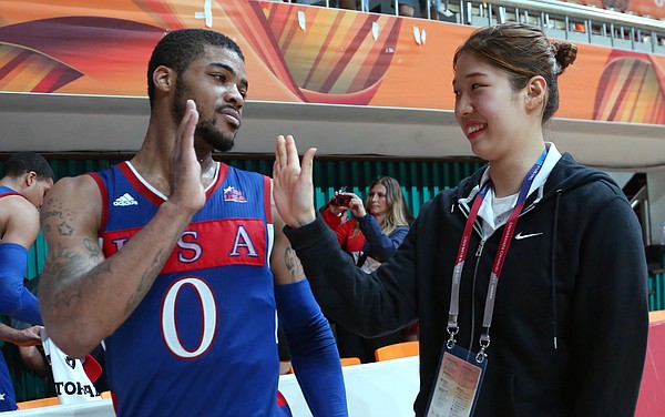 Kansas guard Frank Mason III (0) high-fives a volunteer at the Dongkang College Gymnasium after a Team USA 78-68 semifinal victory over Russia on Sunday, July 12, 2015, at the World University Games in South Korea.