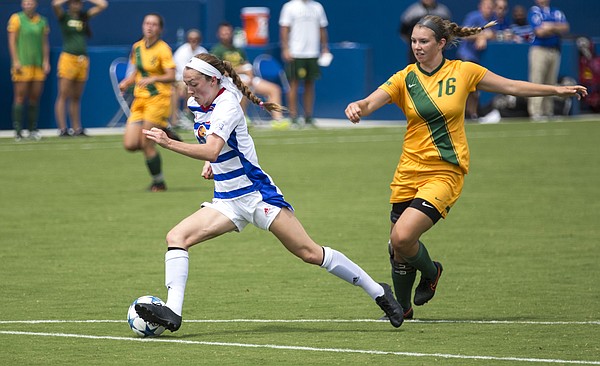 Kansas freshman midfielder Grace Hagan makes a move in the open field to shake North Dakota State junior midfielder Natalie Fenske (16) during their exhibition soccer match Sunday at Rock Chalk Park. The Jayhawks and the Bison played to a 2-2 tie. The Jayhawks start the season on the road with four straight away games beginning in Lincoln, Neb. against Nebraska on Friday, Aug. 21. Kansas then returns to Rock Chalk Park to host Santa Clara in its home opener on Friday, Sept. 4, at 5 p.m.