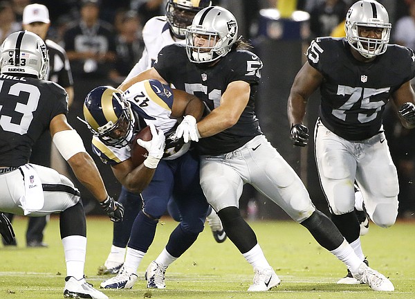 In this Aug. 14, 2015, photo, Oakland Raiders inside linebacker Ben Heeney (51) tackles St. Louis Rams running back Trey Watts (42) during the first half of an NFL preseason football game in Oakland, Calif. Linebacker Heeney's exhibition debut for Oakland went so well that he wanted the jersey as a keepsake. The only problem was it's the only game-ready one the Raiders have for the fifth-round pick. (AP Photo/Tony Avelar)