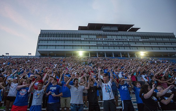 Incoming freshman learn how to wave the wheat  at KU Traditions Night Saturday evening at Memorial Stadium. The annual event held before the start of each new school year aims to teach incoming freshmen about the traditions that make KU unique. 