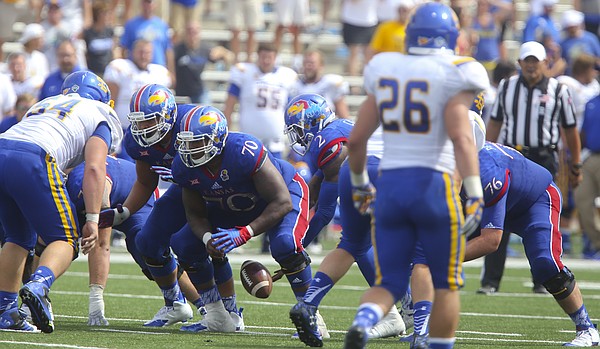 Kansas quarterback Montell Cozart (2) fumbles a snap behind Kansas offensive lineman Keyon Haughton (70) with seven seconds remaining in the game against South Dakota State on Saturday, Sept. 5, 2015 at Memorial Stadium. The error cost the Jayhawks an attempt at a game-tying field goal.