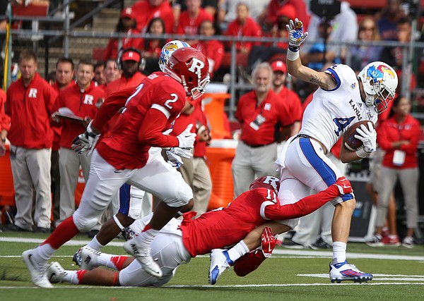 Kansas wide receiver Tyler Patrick (4) is dragged down by Rutgers defensive back Isaiah Wharton (11) after a long gain during the fourth quarter on Saturday, Sept. 26, 2015 at High Point Solutions Stadium in Piscataway, New Jersey.