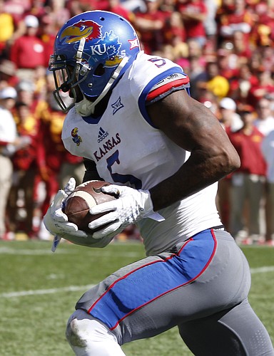 Kansas linebacker Marcquis Roberts (5) runs back an interception for a touchdown during the fourth quarter on Saturday, Oct. 3, 2015 at Jack Trice Stadium in Ames, Iowa.