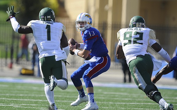 Kansas quarterback Ryan Willis (13) is chased down by Baylor linebacker Taylor Young (1) and defensive end Jamal Palmer (92) during the first quarter on Saturday, Oct. 10, 2015 at Memorial Stadium.
