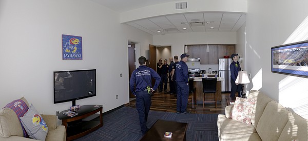 Members of the Lawrence-Douglas County Fire Medical department tour a living unit at the new $11.2 million McCarthy Hall, which houses the Kansas men's basketball team.