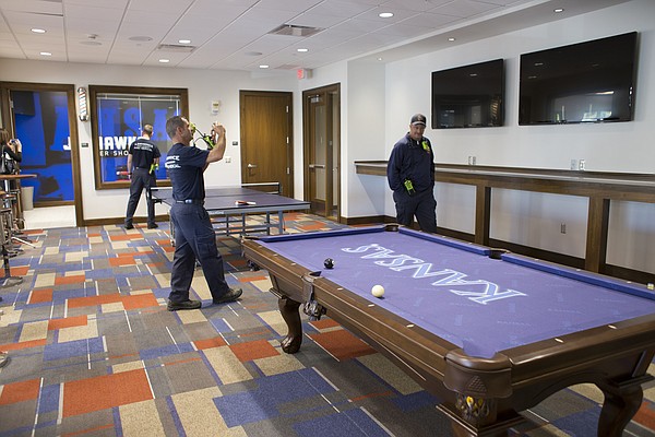 Lawrence-Douglas County Fire and Medical personnel tour a recreation room at the new $11.2 million McCarthy Hall, which houses the Kansas men's basketball team.