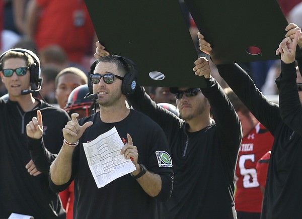 Texas Tech head coach Kliff Kingsbury calls a play from the sidelines during the first half of an NCAA college football game against TCU Saturday, Sept. 26, 2015, in Lubbock, Texas. (AP Photo/LM Otero)